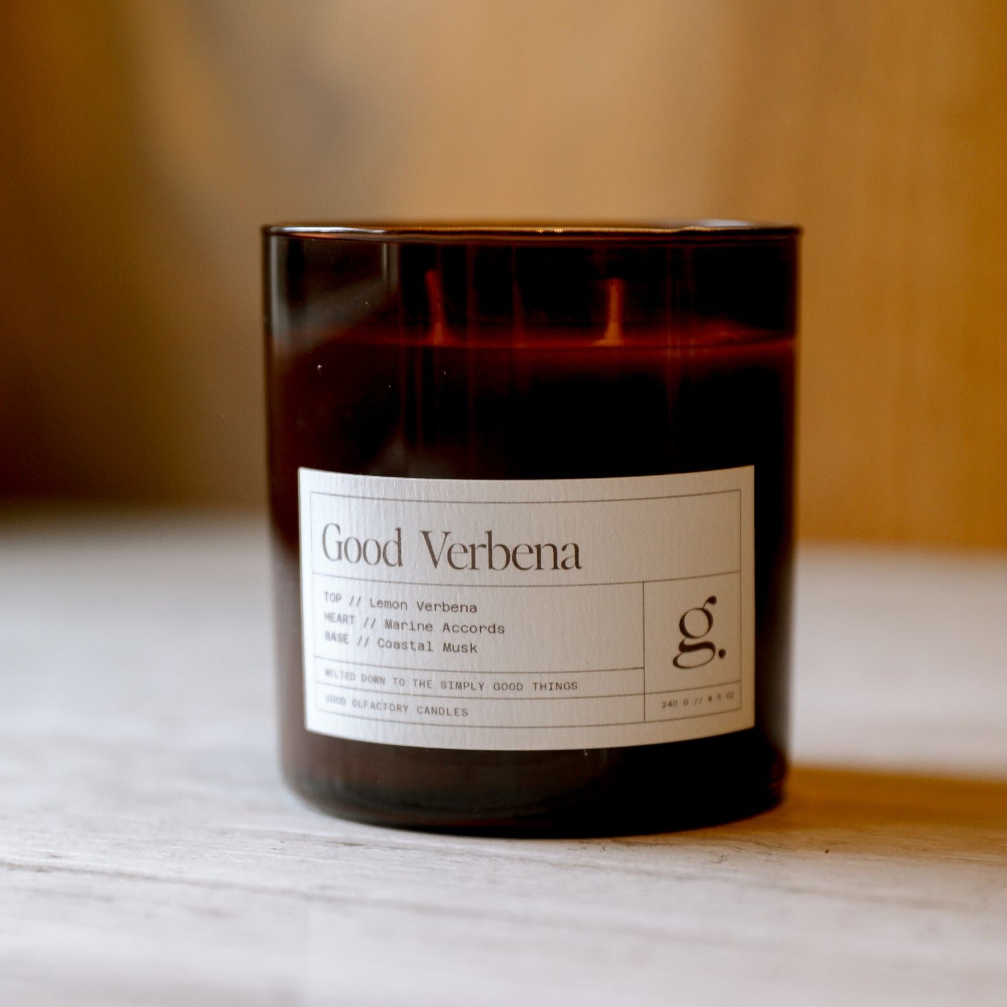 Candle with a label on a white surface